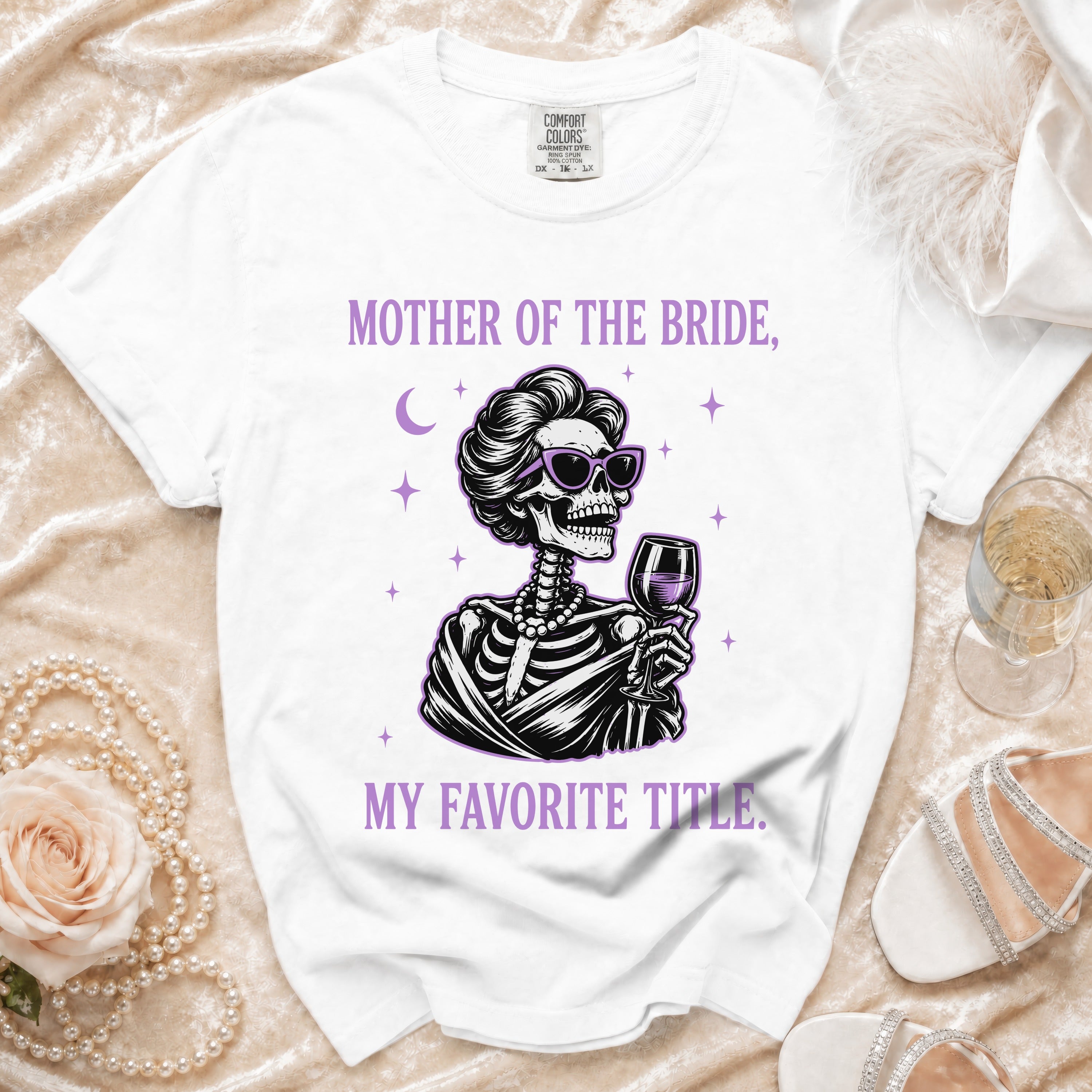 White t-shirt with skeleton graphic and text "Mother of the Bride, My Favorite Title."