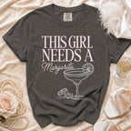 Comfort Colors t-shirt with "This Girl Needs A Margarita" text and margarita illustration.