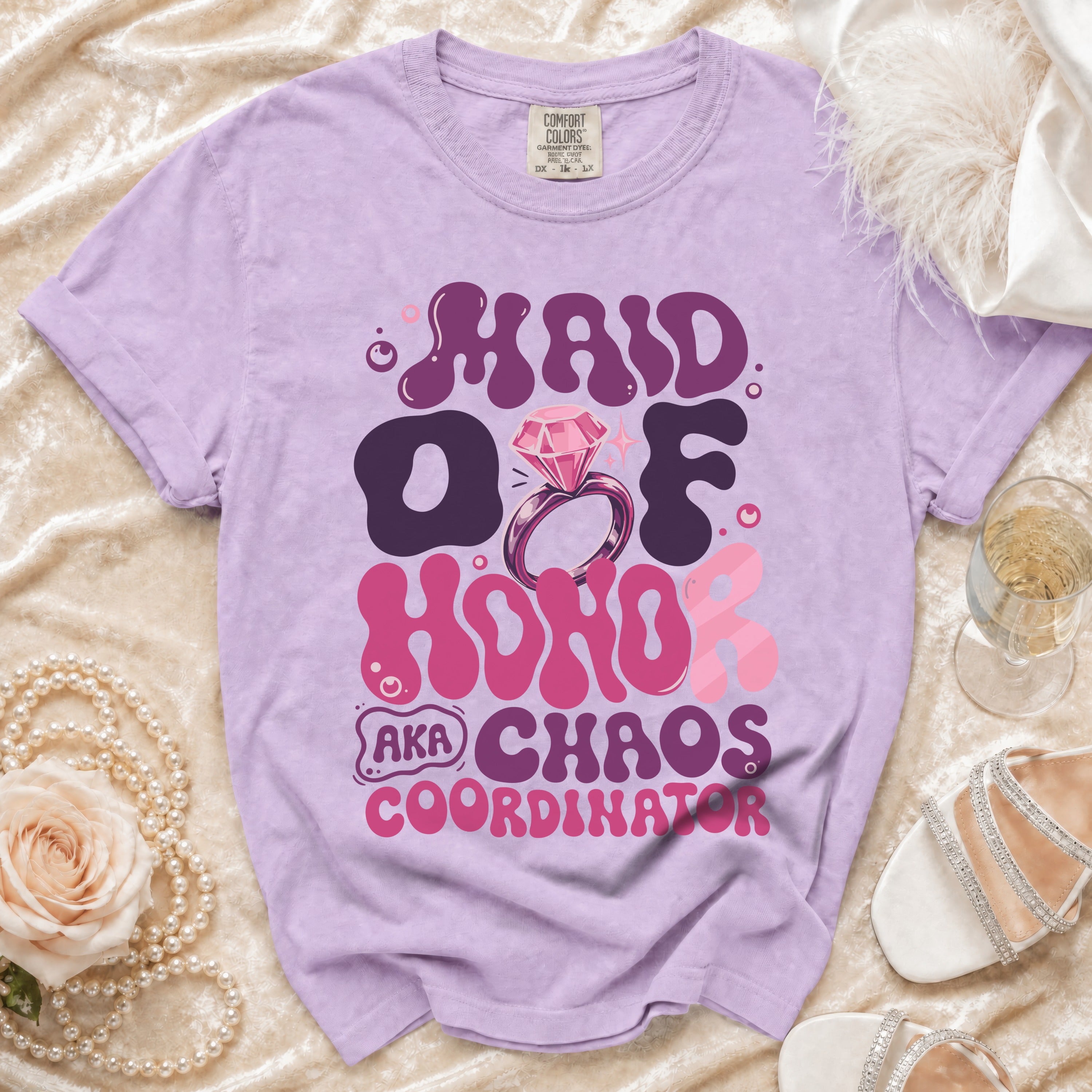 Maid of Honor AKA Chaos Coordinator text on lavender t-shirt with ring graphic.