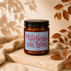 Glass candle with "Two brides, one home" text, "VOWED" brand.