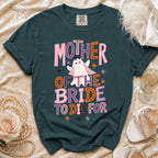 A dark teal t-shirt featuring a ghost graphic and the text Mother of the Bride to Die For.