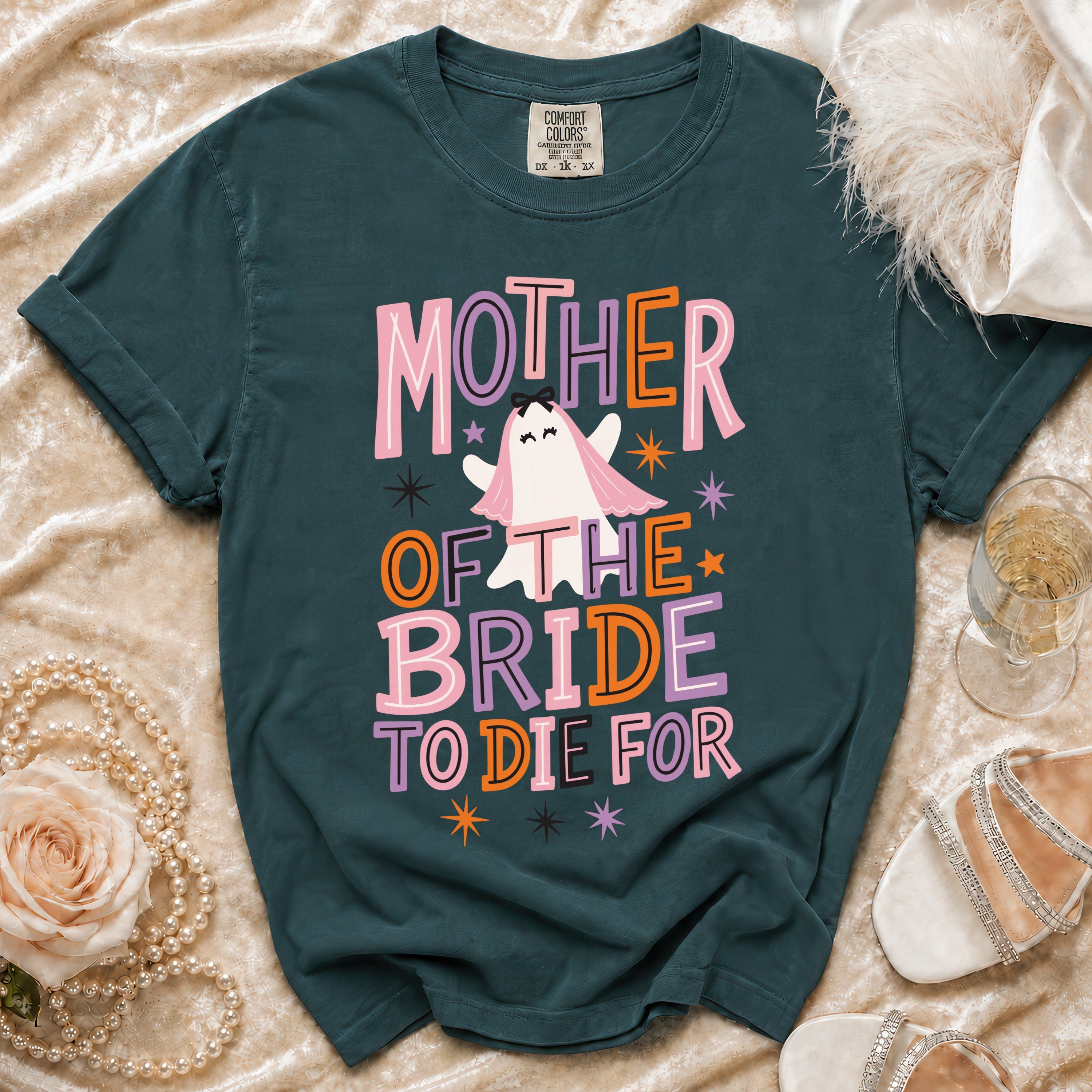 A dark teal t-shirt featuring a ghost graphic and the text Mother of the Bride to Die For.