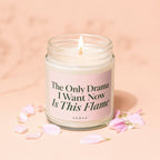 Scented candle in glass jar with pink label reading "The Only Drama I Want Now Is This Flame."