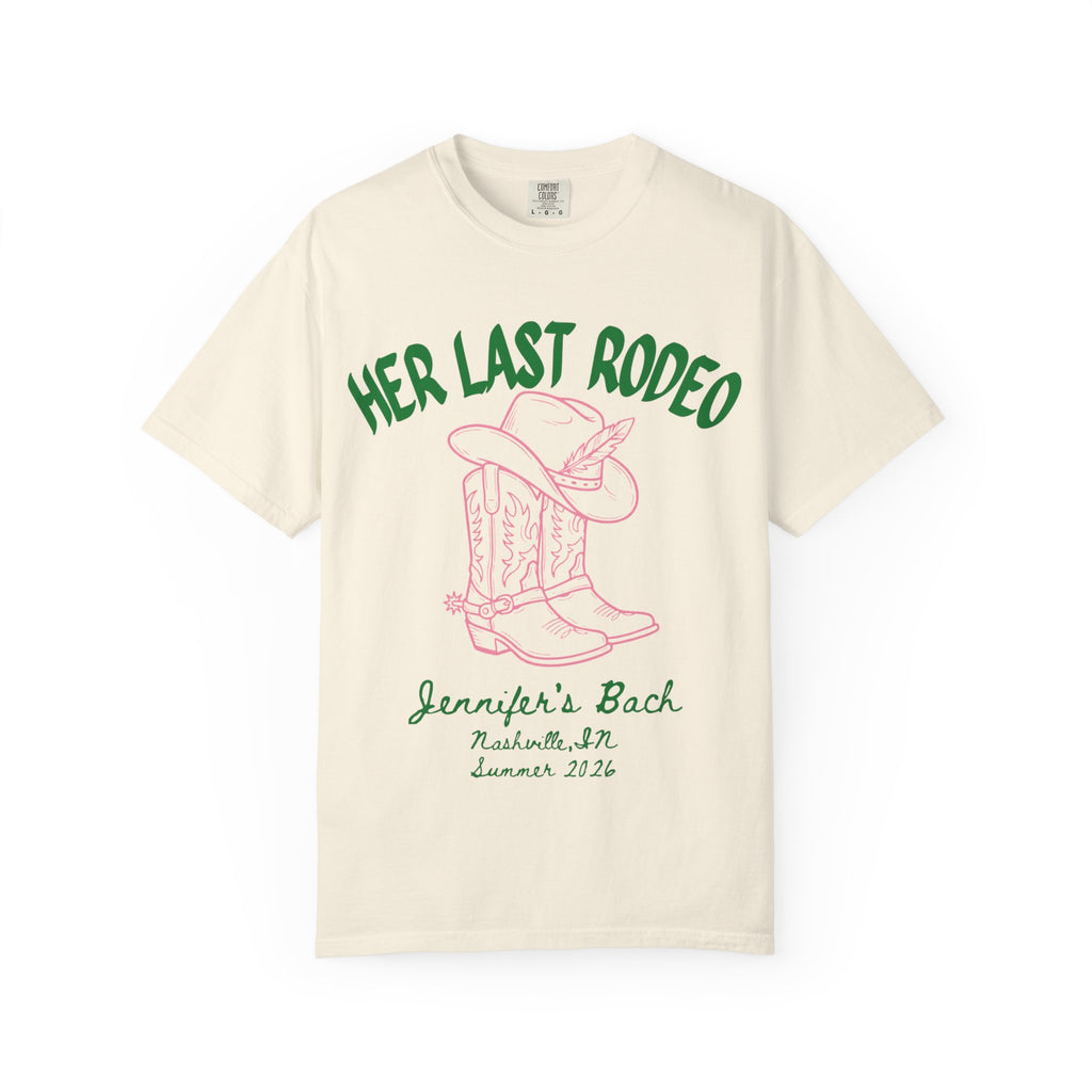 Cream t-shirt with "Her Last Rodeo" text, cowboy boots, and hat.