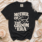 Black t-shirt with "Mother of the Groom Era" text and heart-shaped glasses graphic.