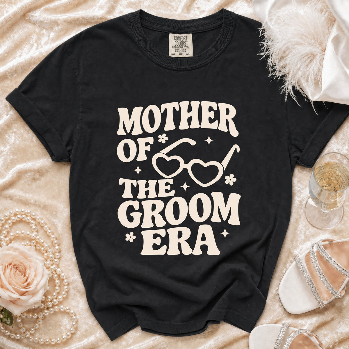 Black t-shirt with "Mother of the Groom Era" text and heart-shaped glasses graphic.