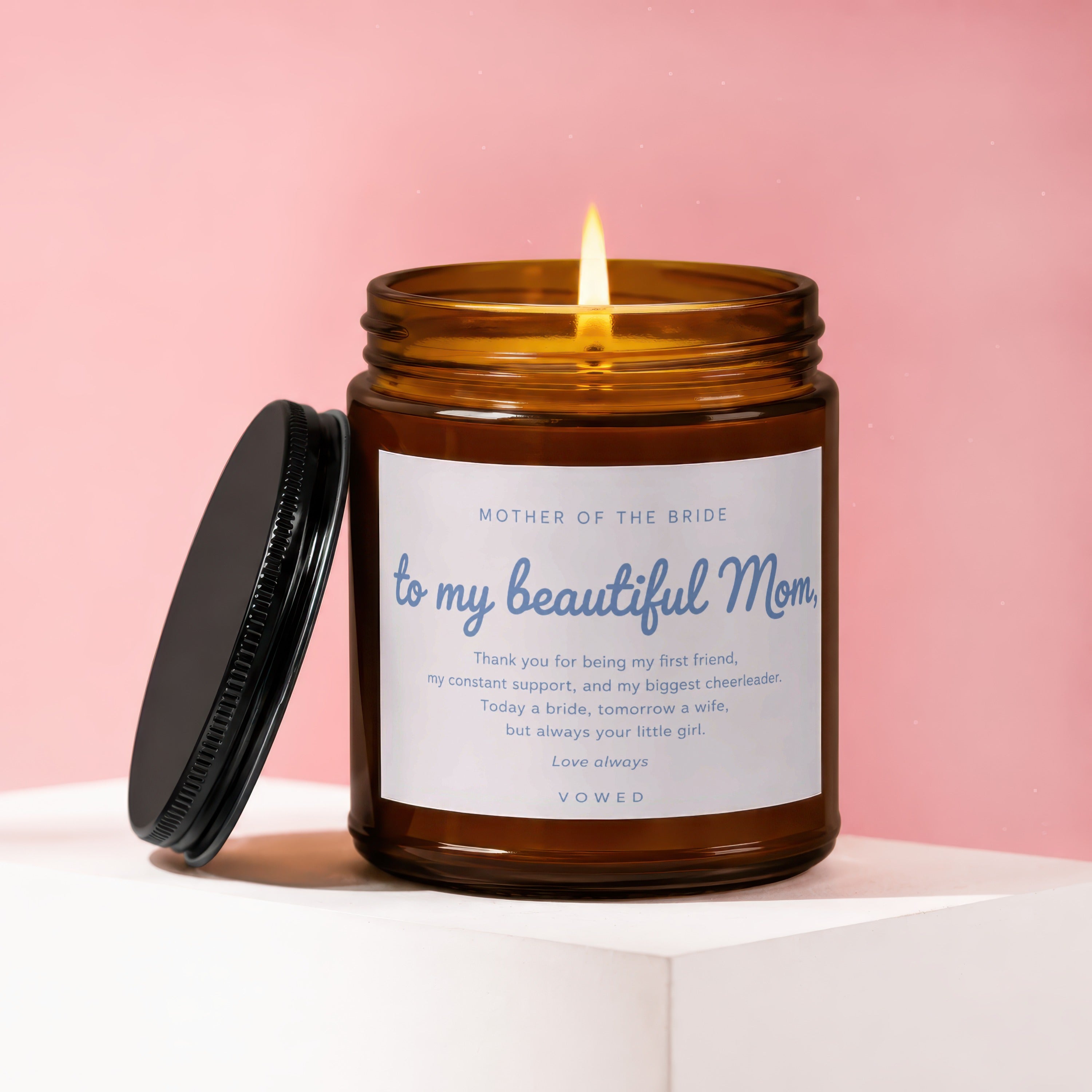 Amber candle with burning flame, lid off, labeled "Mother of the Bride to my beautiful Mom."