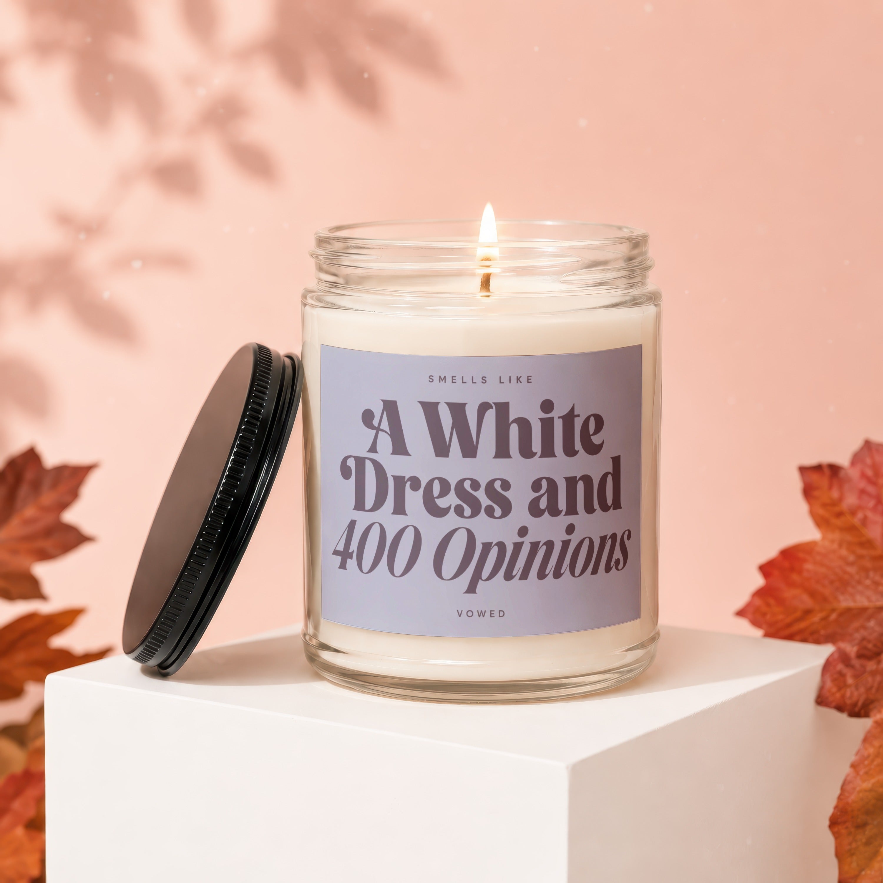 Scented candle with "A White Dress & 400 Opinions" label.