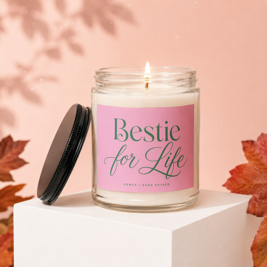 Glass candle with pink label reading "Bestie for Life", with lid off.