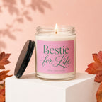 Glass candle with pink label reading "Bestie for Life", with lid off.