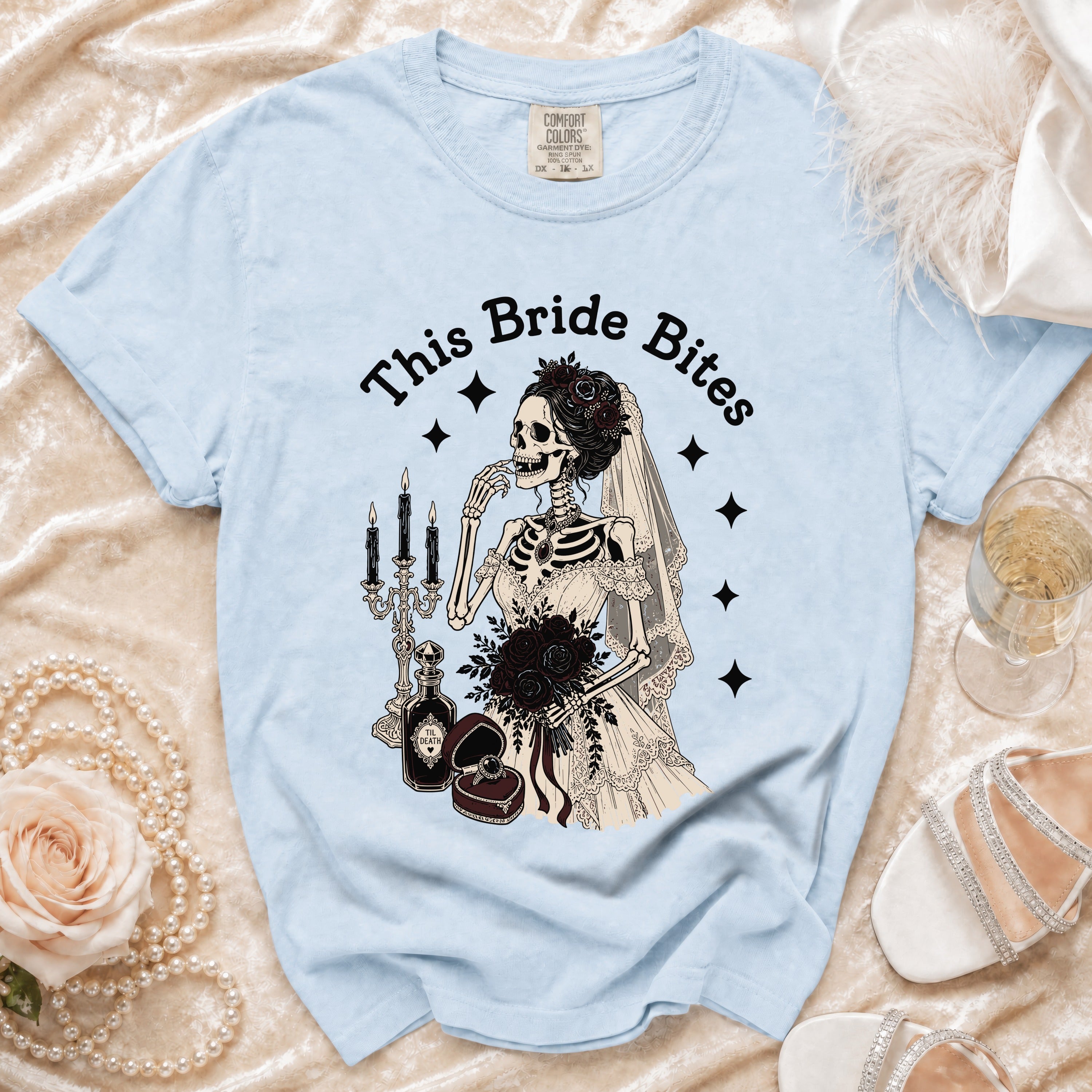 Light blue t-shirt with skeleton bride graphic and text "This Bride Bites".