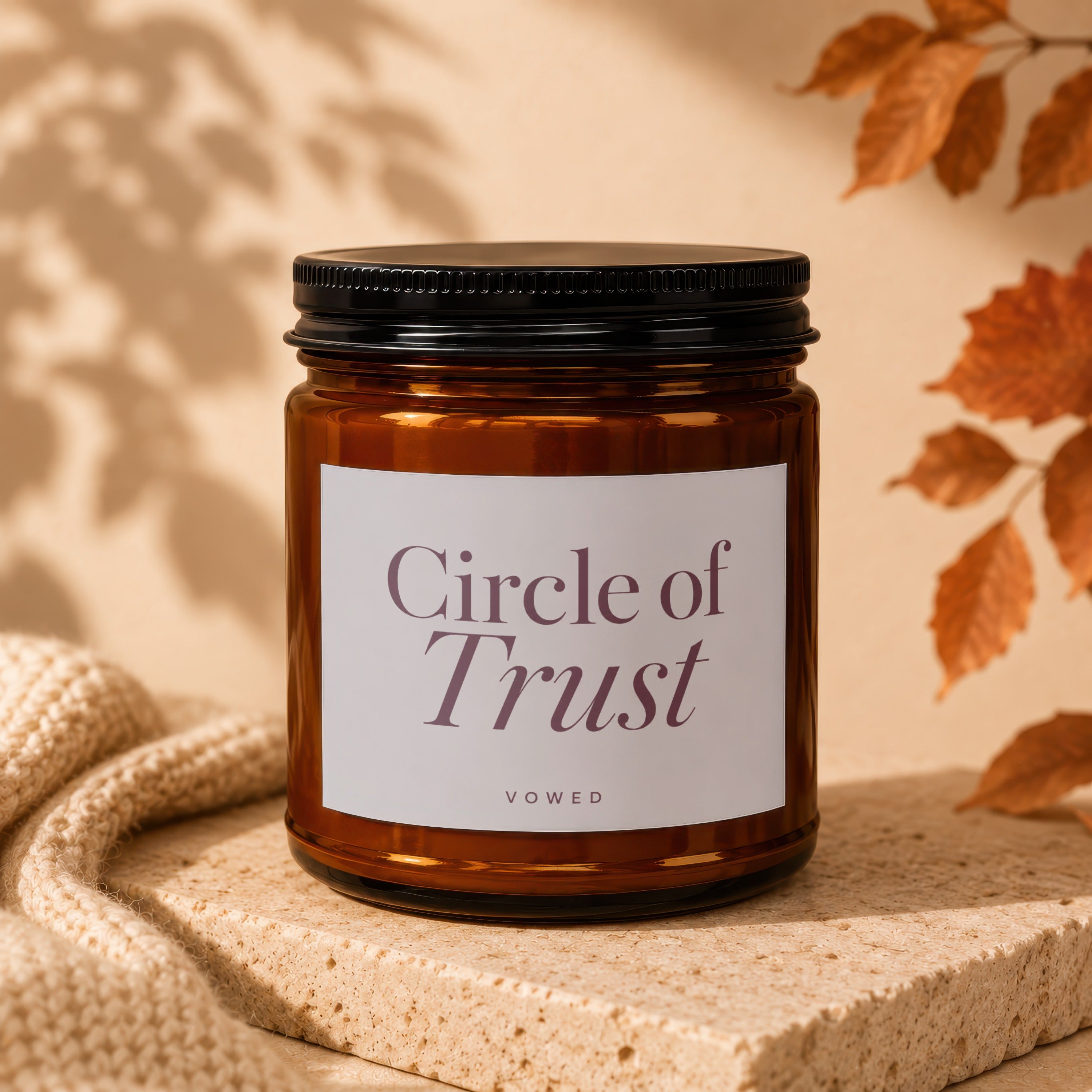 Amber glass candle with white label reading "Circle of Trust VOWED".
