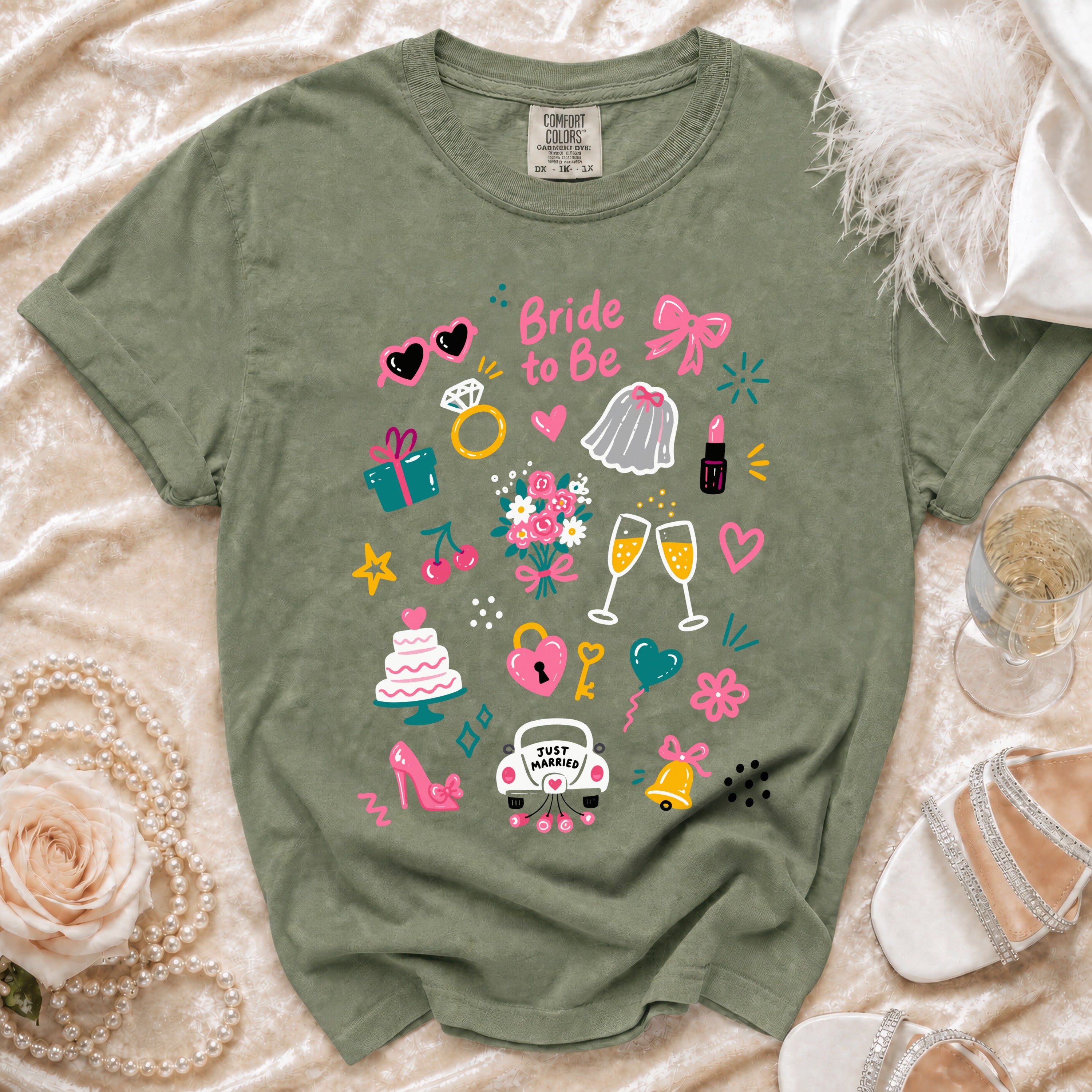 Olive green t-shirt with "Bride to Be" text and wedding themed graphics.
