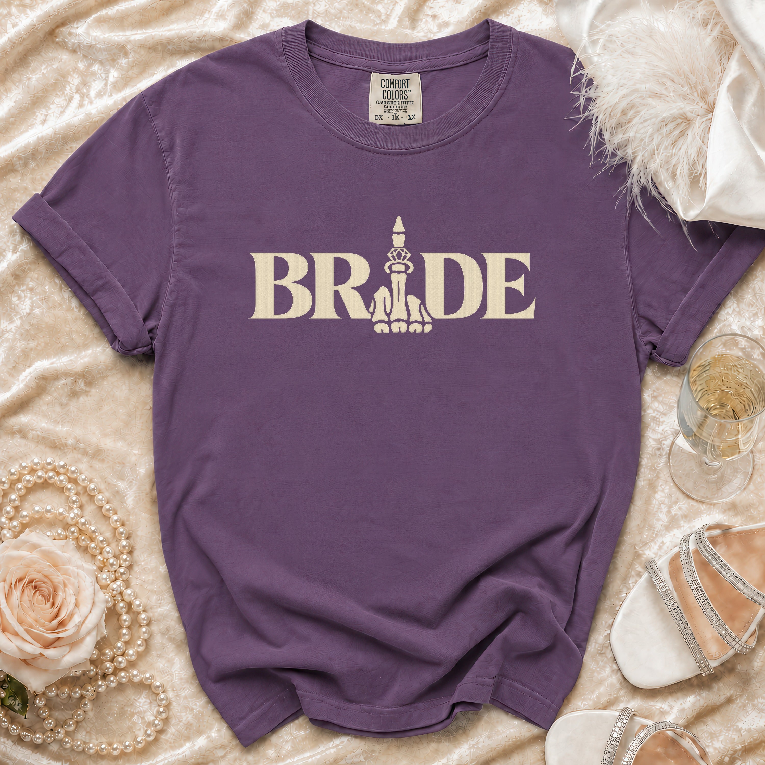 Purple t-shirt with "BRIDE" text and a skeleton middle finger graphic.