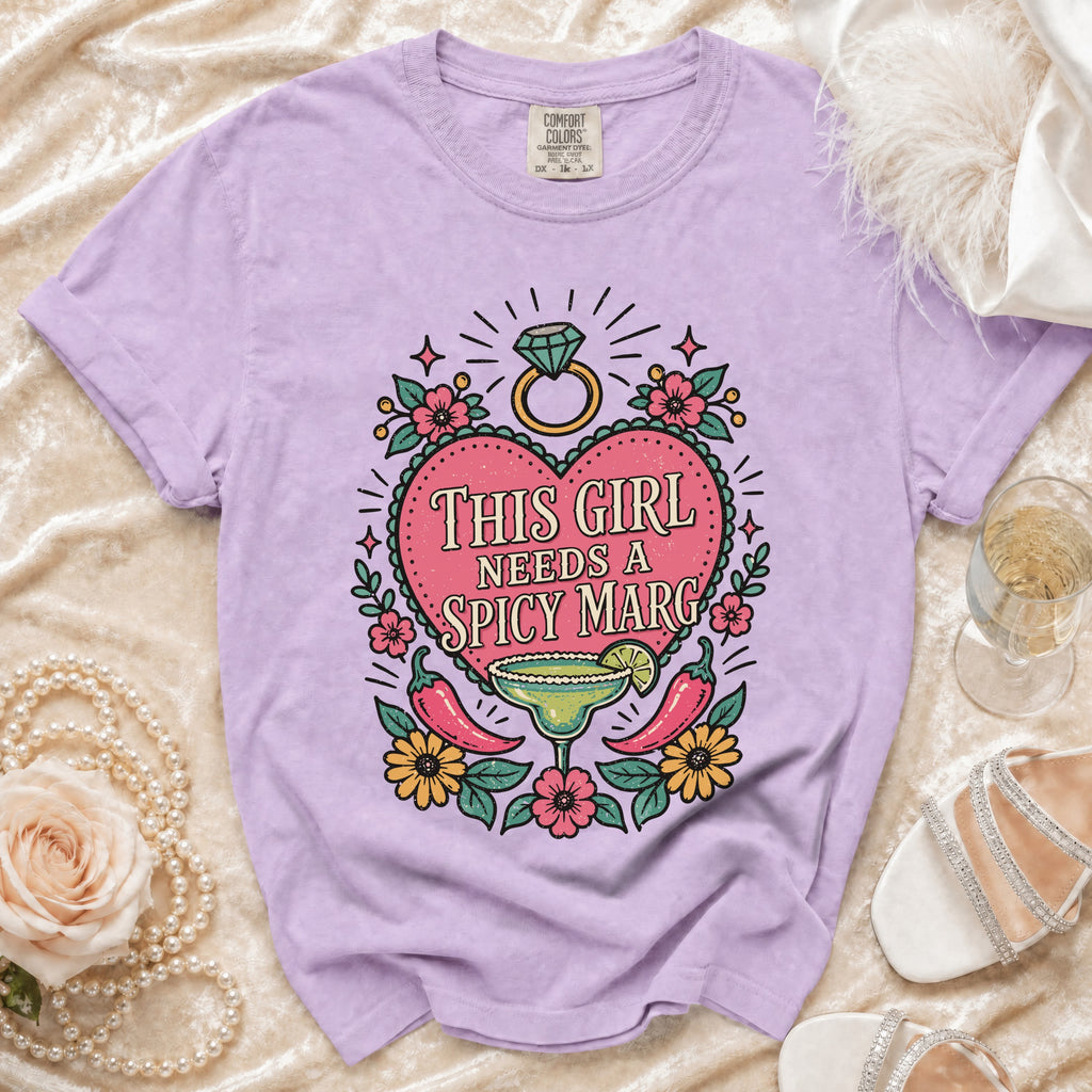 Purple t-shirt with "This Girl Needs A Spicy Marg" graphic featuring margarita and peppers.