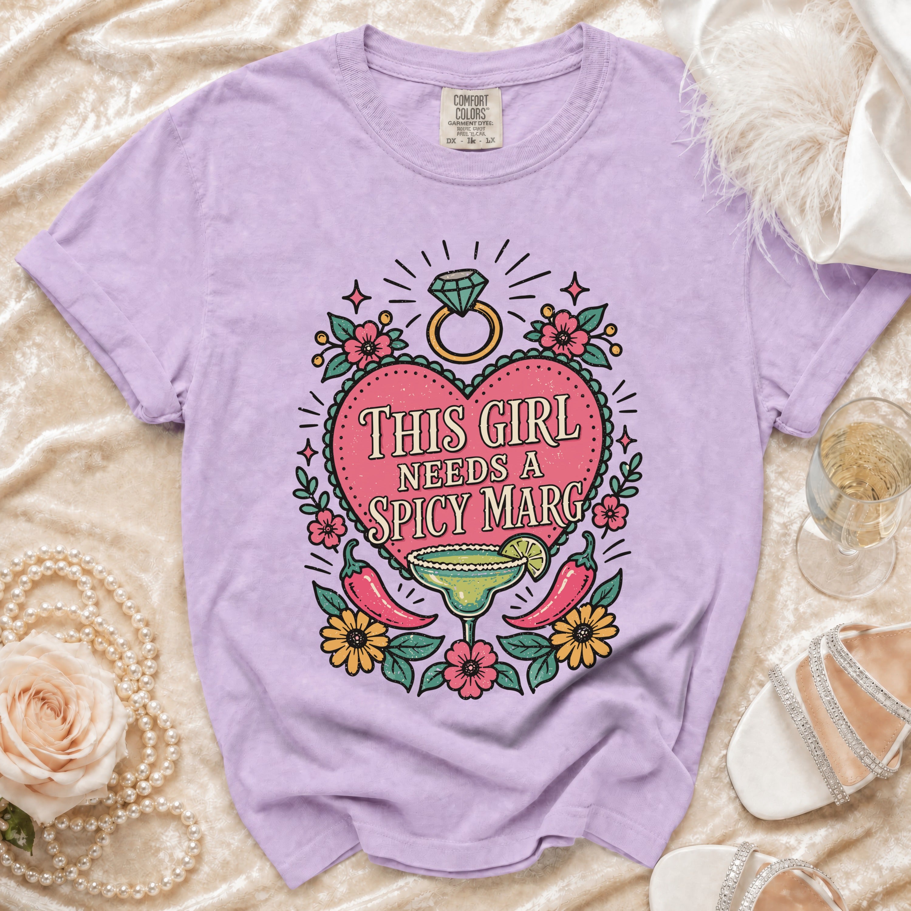 Purple t-shirt with "This Girl Needs A Spicy Marg" graphic featuring margarita and peppers.