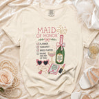 Maid of Honor t-shirt with checklist, champagne, and bridal accessories graphic.