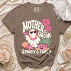 Brown t-shirt with "Mother of the Groom Spooky & Proud" text and a ghost graphic.