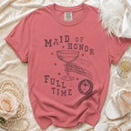 Coral t-shirt with text "Maid of Honor Full Time" and graphic of skeleton hand holding champagne.