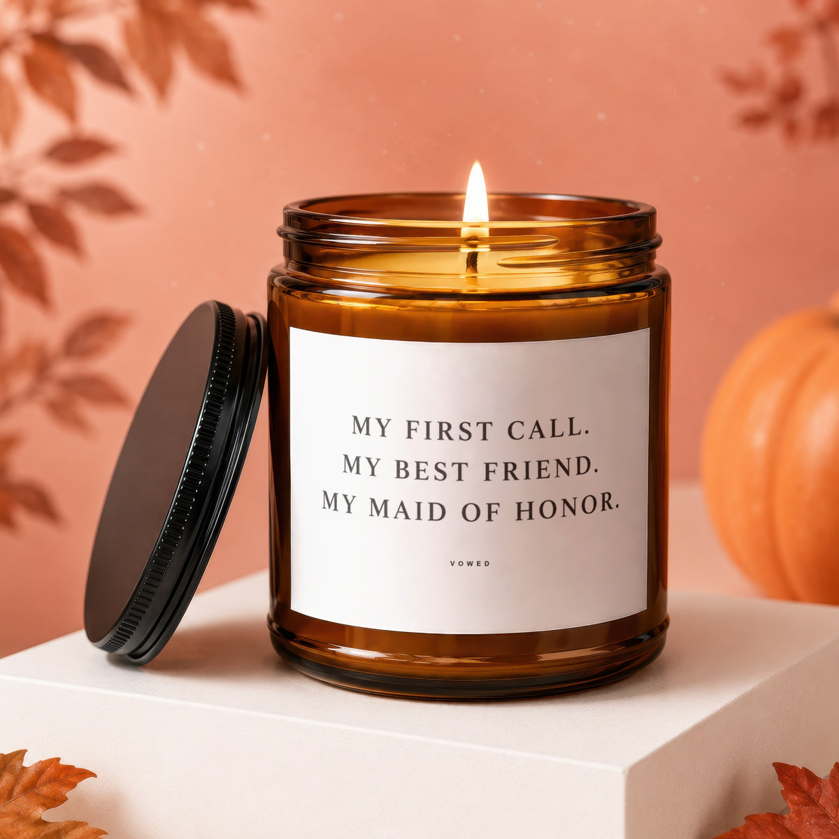Amber jar candle with a lit wick, reading "My First Call. My Best Friend. My Maid of Honor."