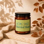 Amber glass candle with a black lid and a "HOME SWEET Married Home VOWED" label.