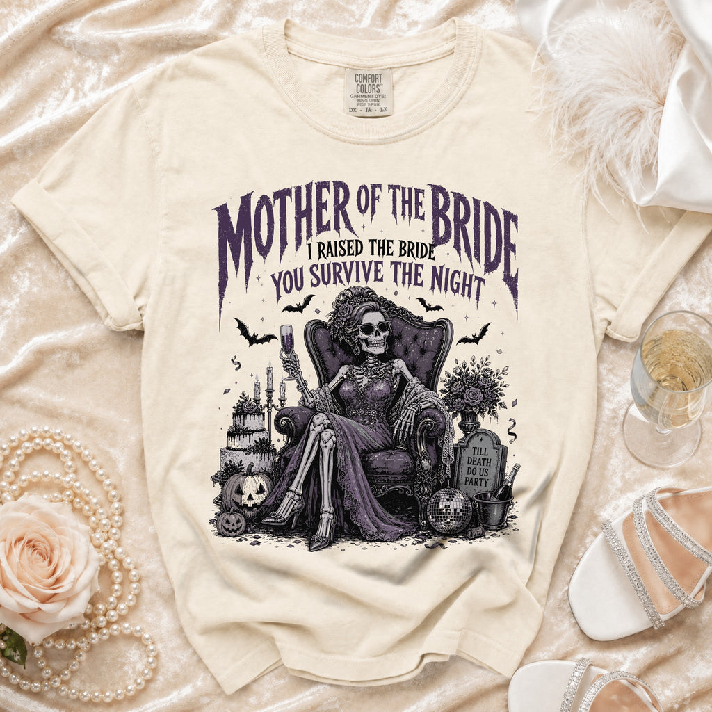 Cream t-shirt with "Mother of the Bride I Raised the Bride You Survive the Night" text and skeleton bride illustration.