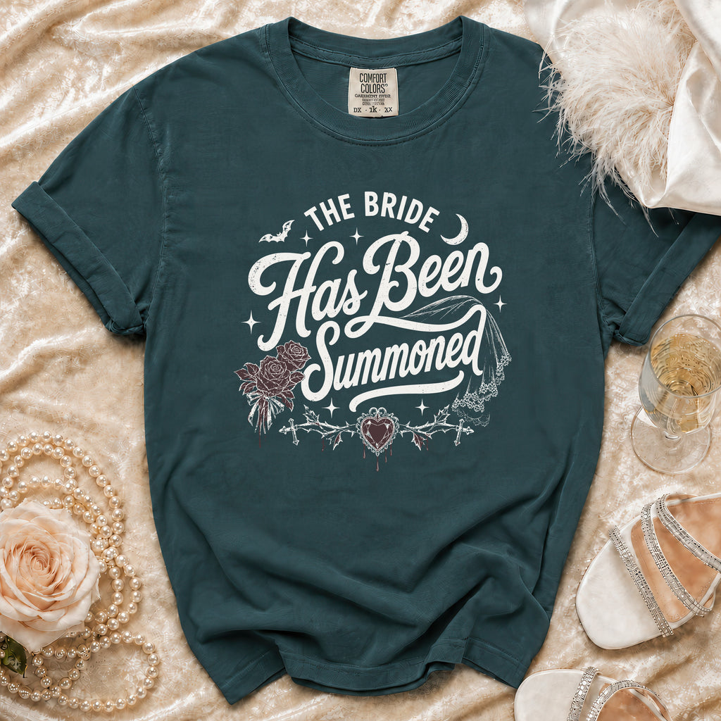 Teal t-shirt with "The Bride Has Been Summoned" graphic, roses, and crosses.
