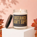 Candle with text "Distance Ain't Sh*t" on black label.