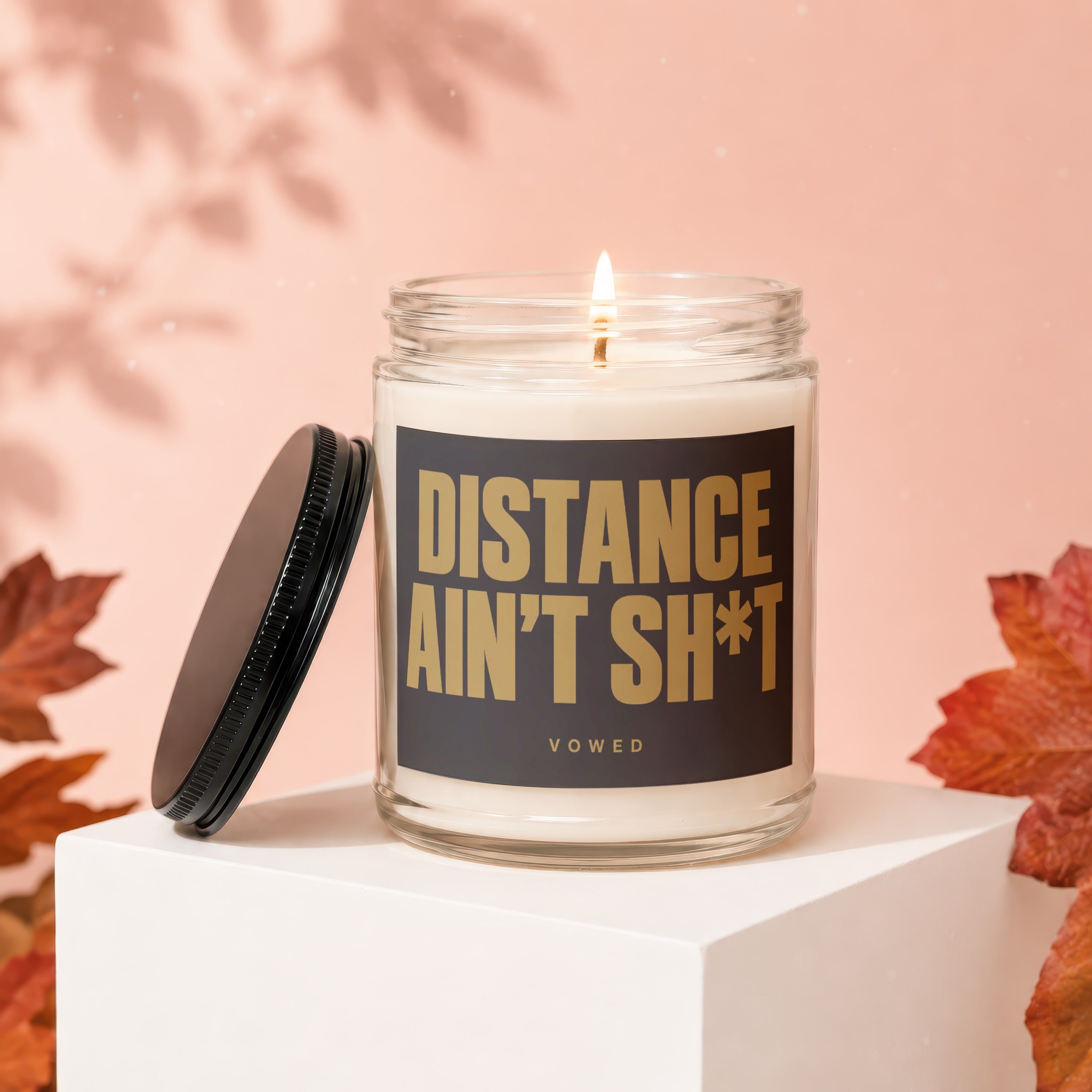 Candle with text "Distance Ain't Sh*t" on black label.