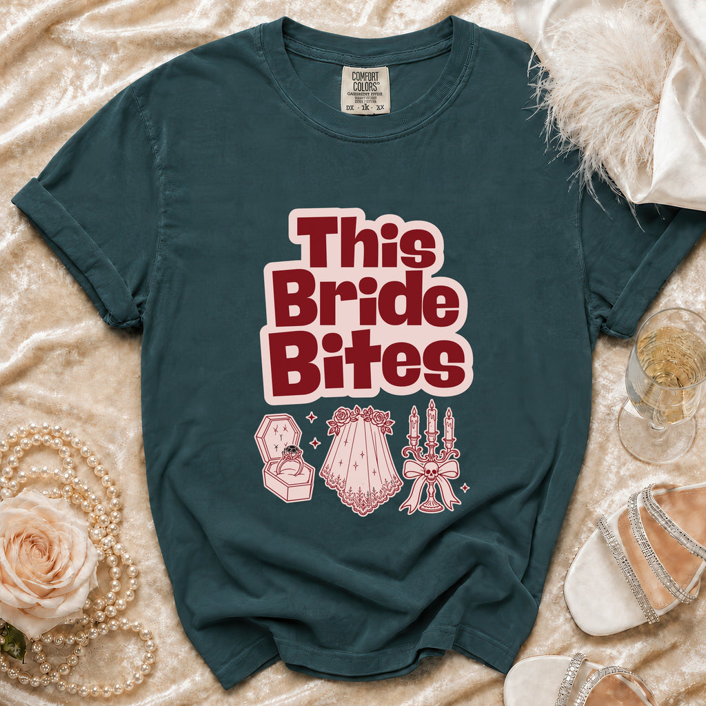 Teal t-shirt with "This Bride Bites" text and wedding-themed graphics.