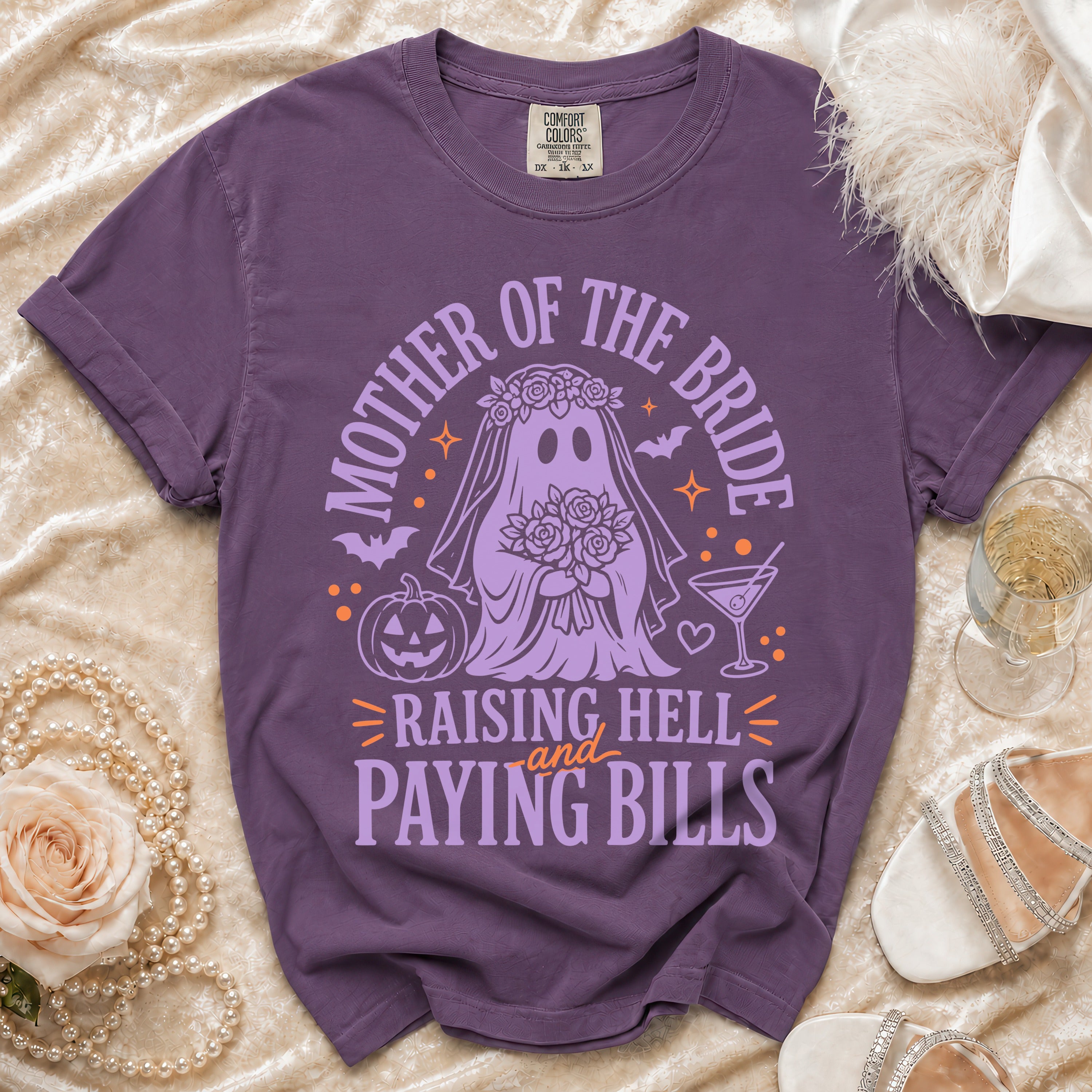 Purple t-shirt with a ghost bride graphic and text "Mother of the Bride Raising Hell and Paying Bills."