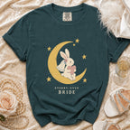 Teal t-shirt with a bride bunny on a moon and stars, reading "Starry-Eyed Bride".