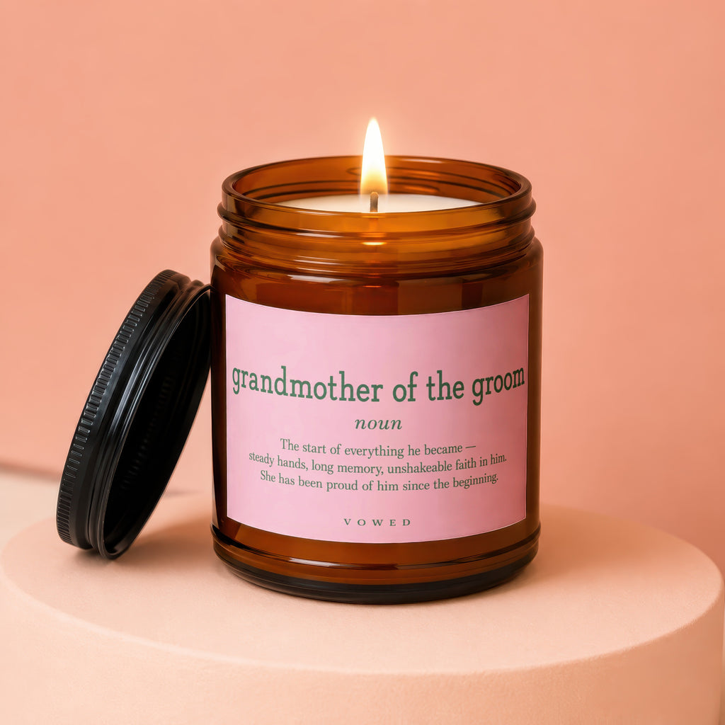 Candle labeled "grandmother of the groom" with definition, on a pink platform.