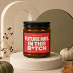 Brown candle with red label reading "Future Mrs. in This B*tch".