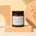 Amber jar candle with "mother of the bride" text and definition.