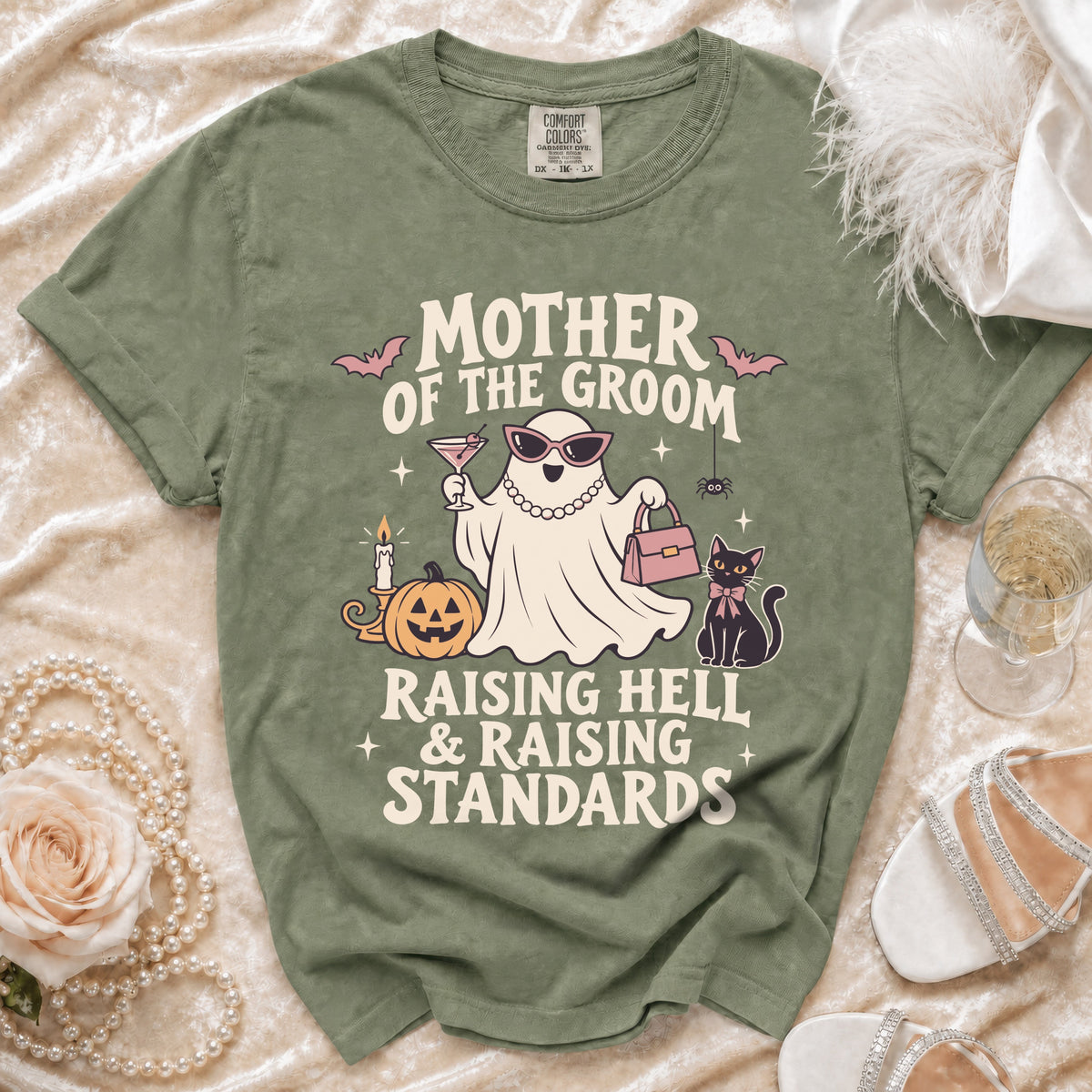 Green t-shirt with "Mother of the Groom Raising Hell & Raising Standards" text and ghost graphic.
