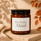 Brown glass candle with black lid labeled "The Perfect Match Vowed".