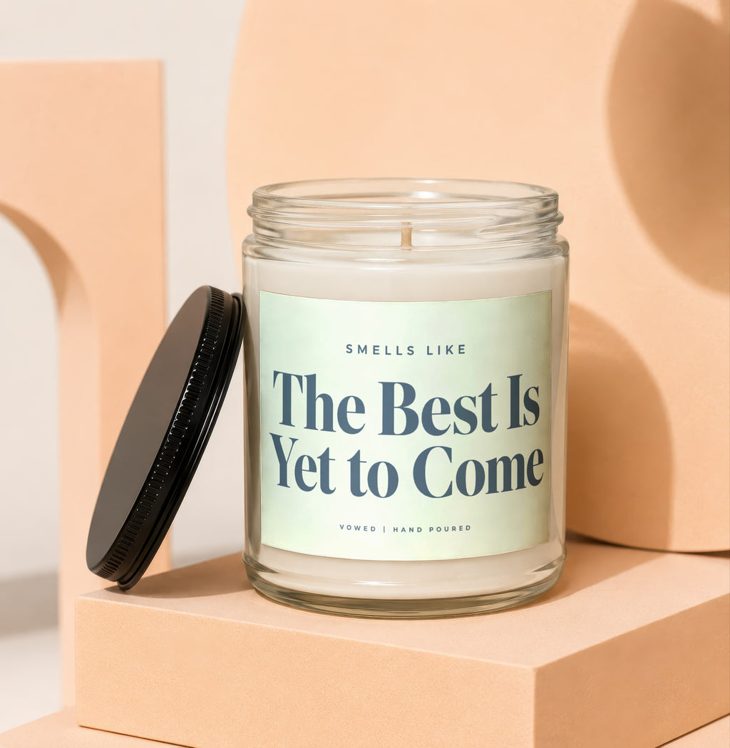 Glass candle with label reading "Smells Like The Best Is Yet to Come".