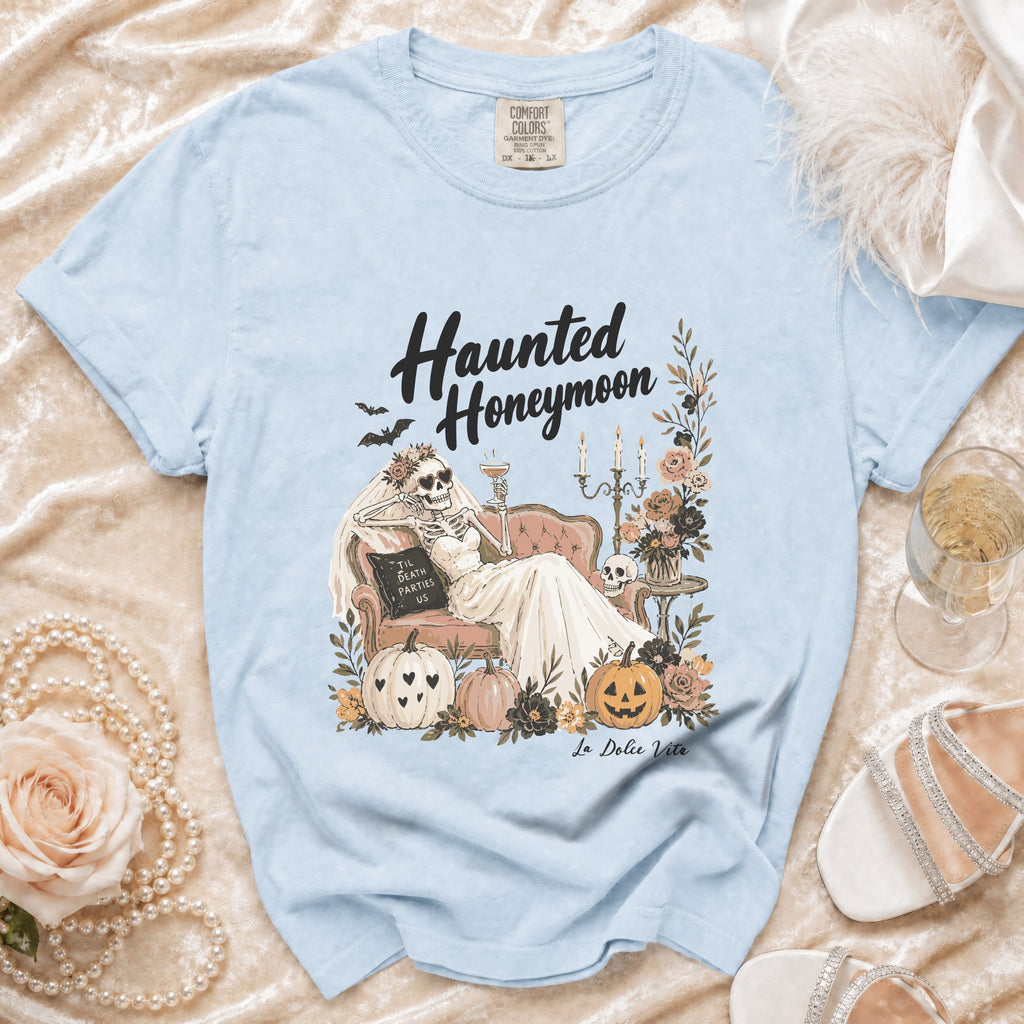 Light blue t-shirt with "Haunted Honeymoon" graphic and "La Dolce Vita" text.