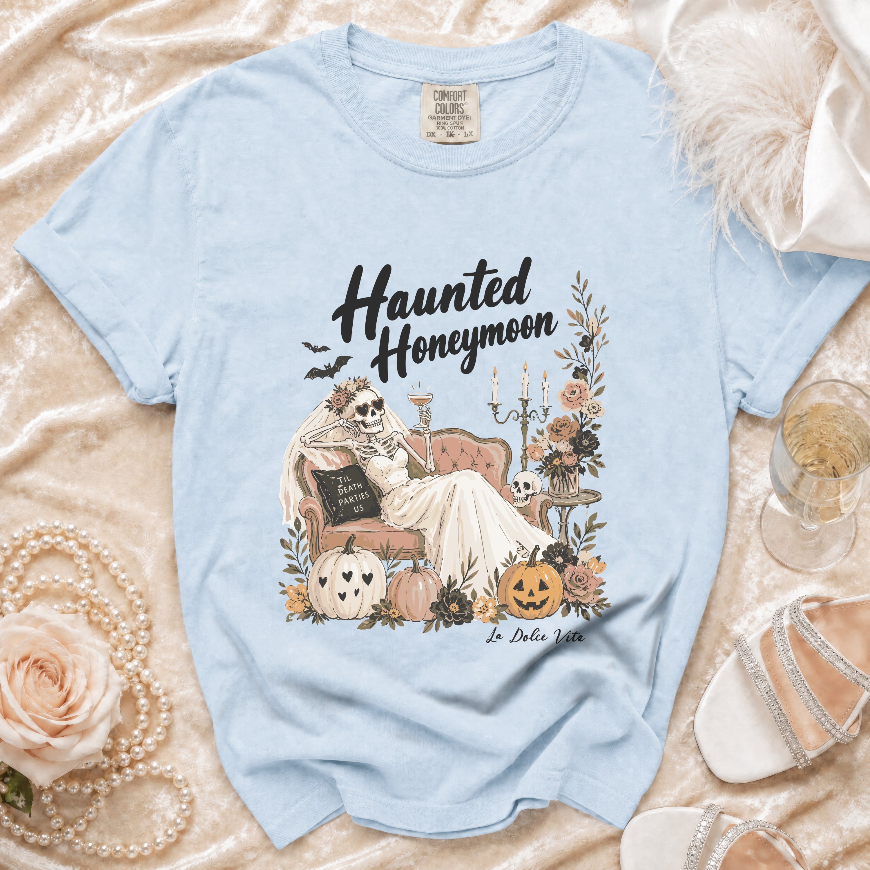 Light blue t-shirt with "Haunted Honeymoon" graphic and "La Dolce Vita" text.