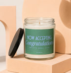Candle with "NOW ACCEPTING Congratulations" text on green label.
