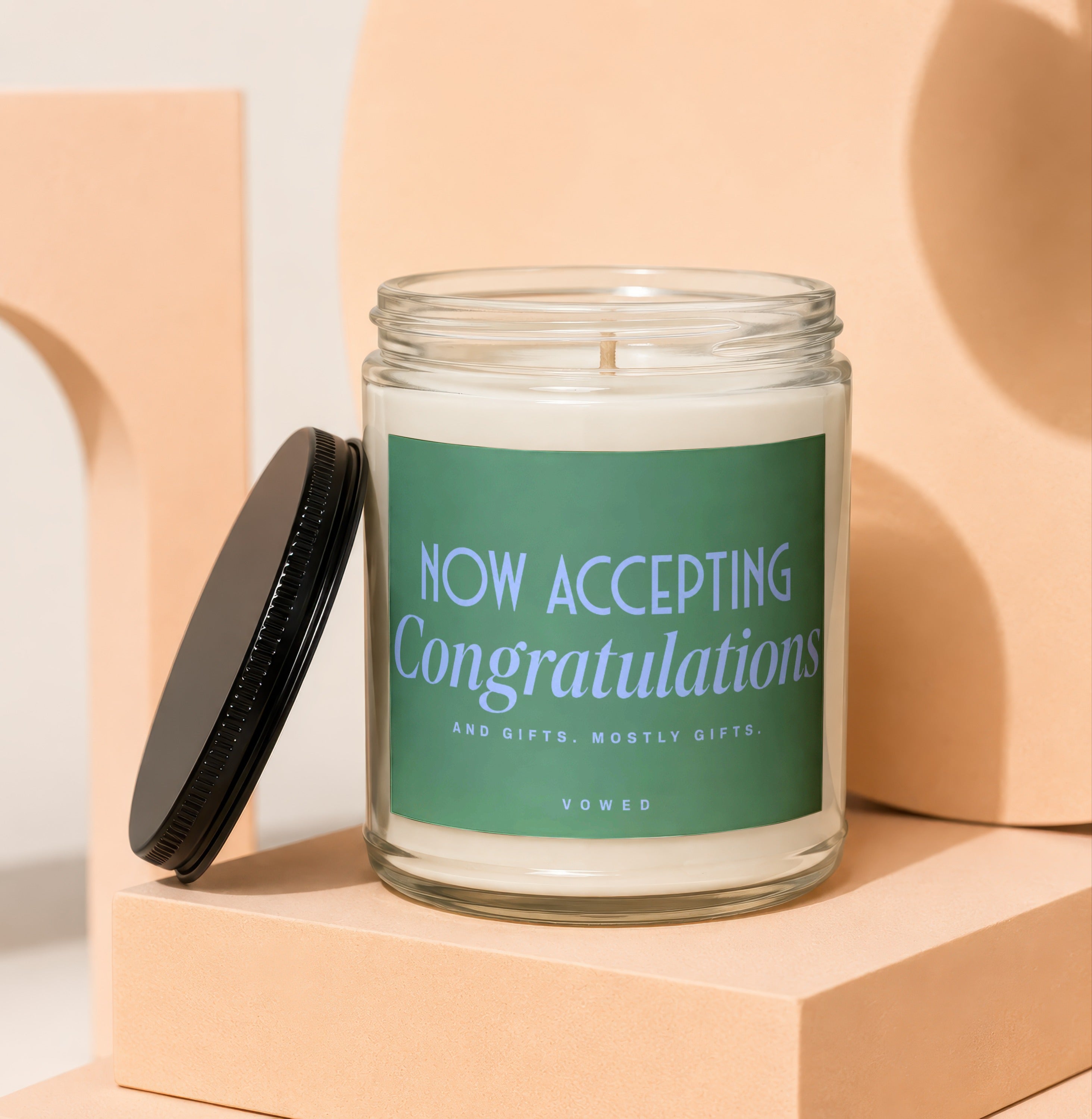 Candle with "NOW ACCEPTING Congratulations" text on green label.