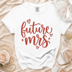 White t-shirt with red text "future mrs" and small hearts.