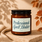 Amber jar candle labeled "Professional Spell Holder" with a beige background and fall leaves.