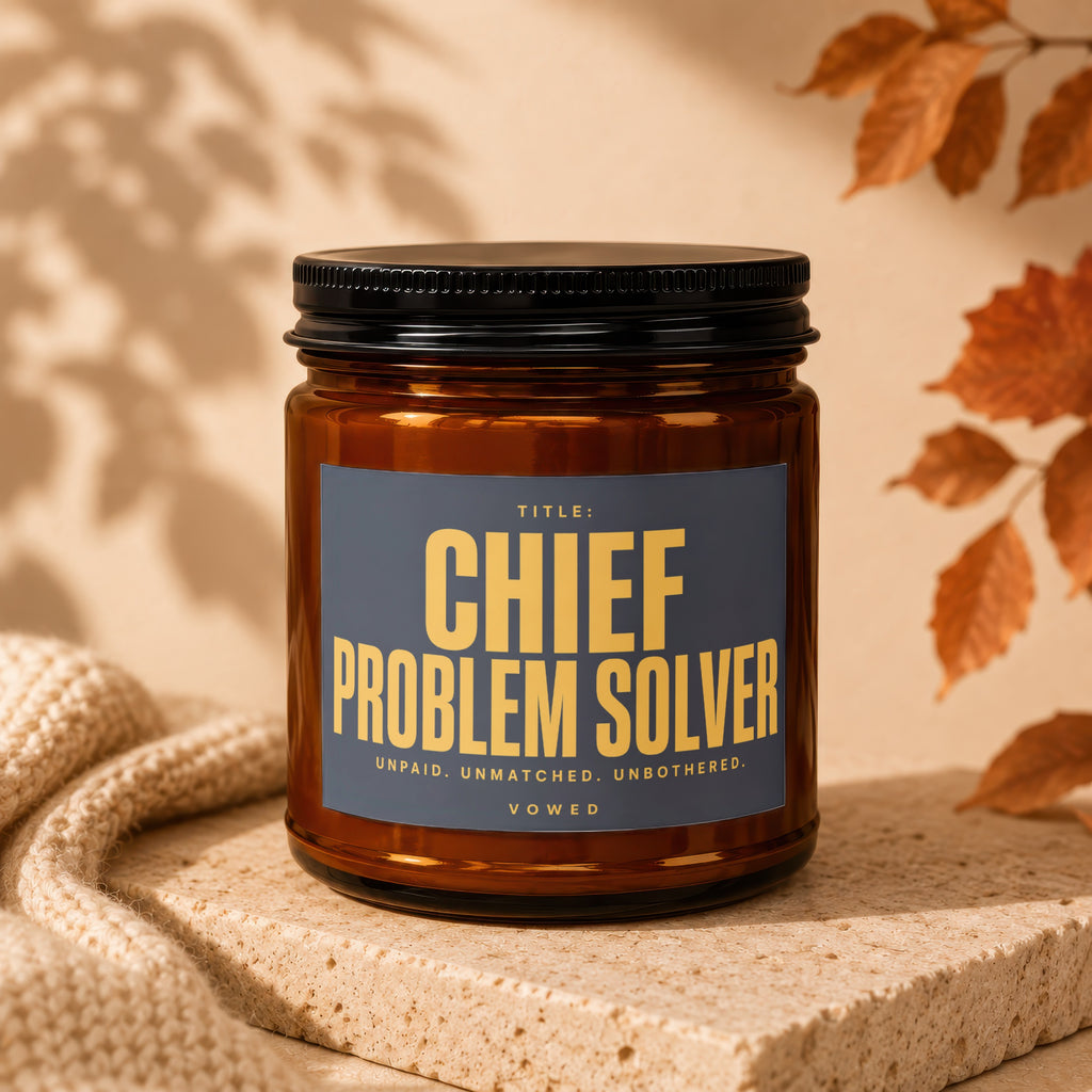 Brown glass candle with "Chief Problem Solver" label.