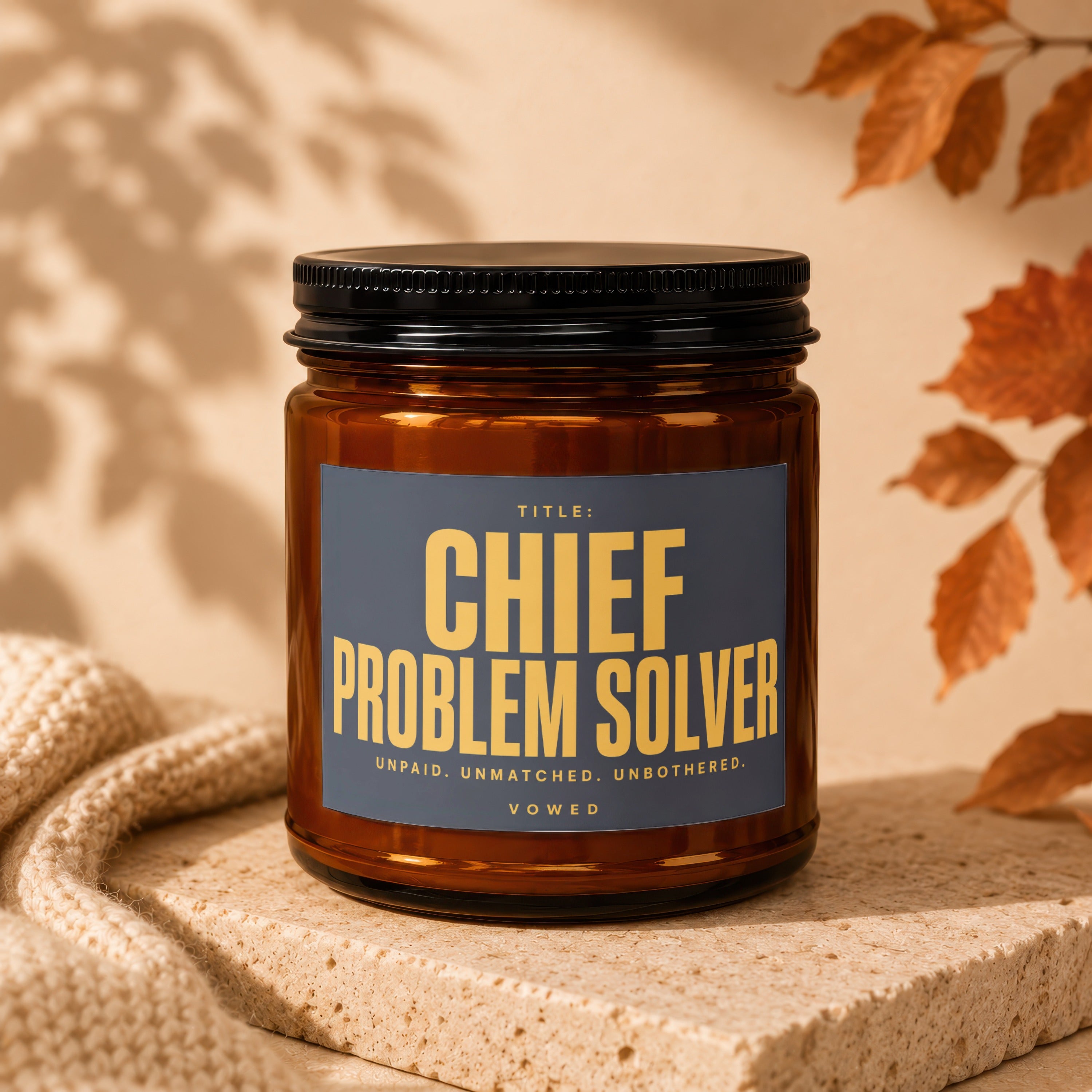 Brown glass candle with "Chief Problem Solver" label.