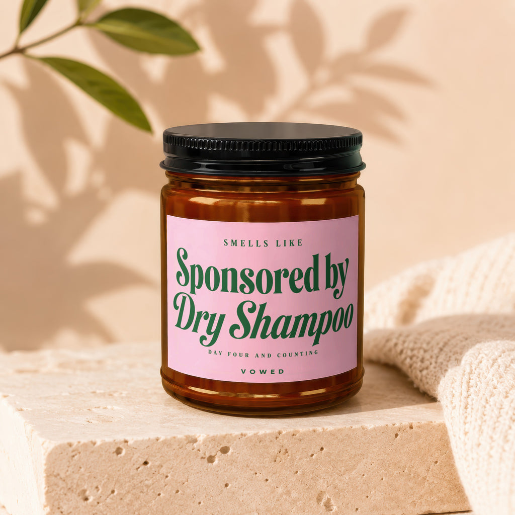 Amber jar with pink label that reads "Smells Like Sponsored By Dry Shampoo".