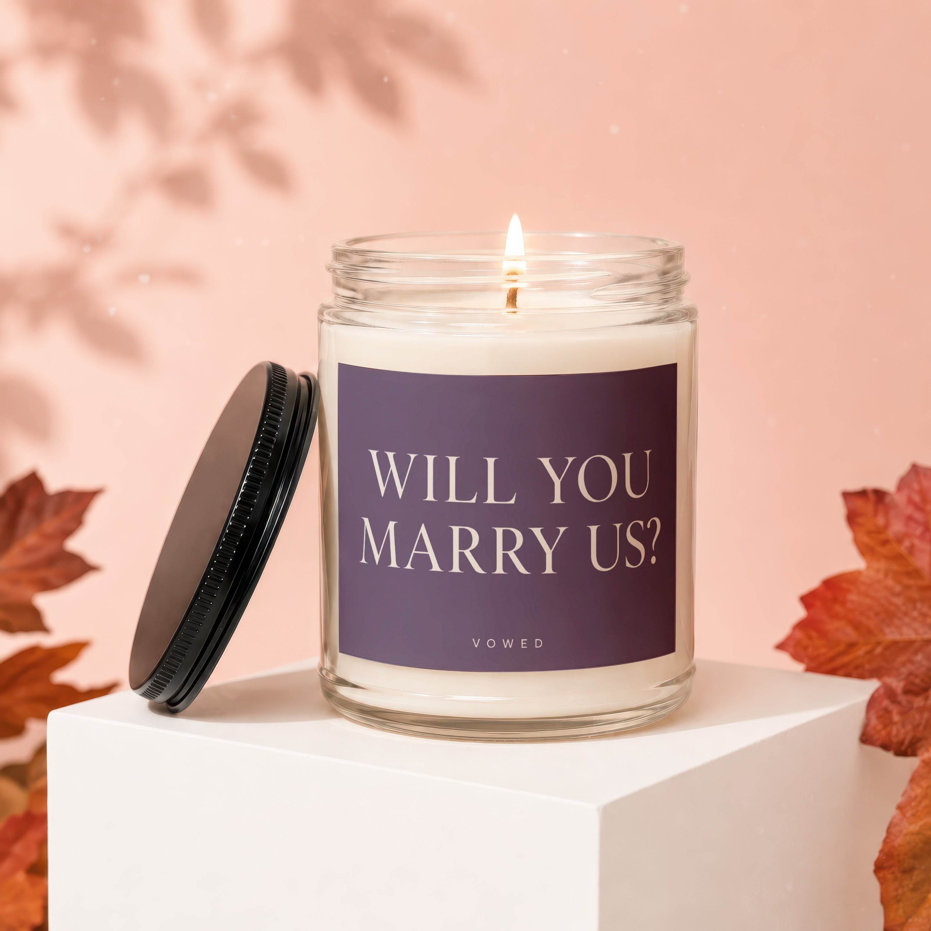 Candle with "Will You Marry Us?" text and "Vowed" logo.