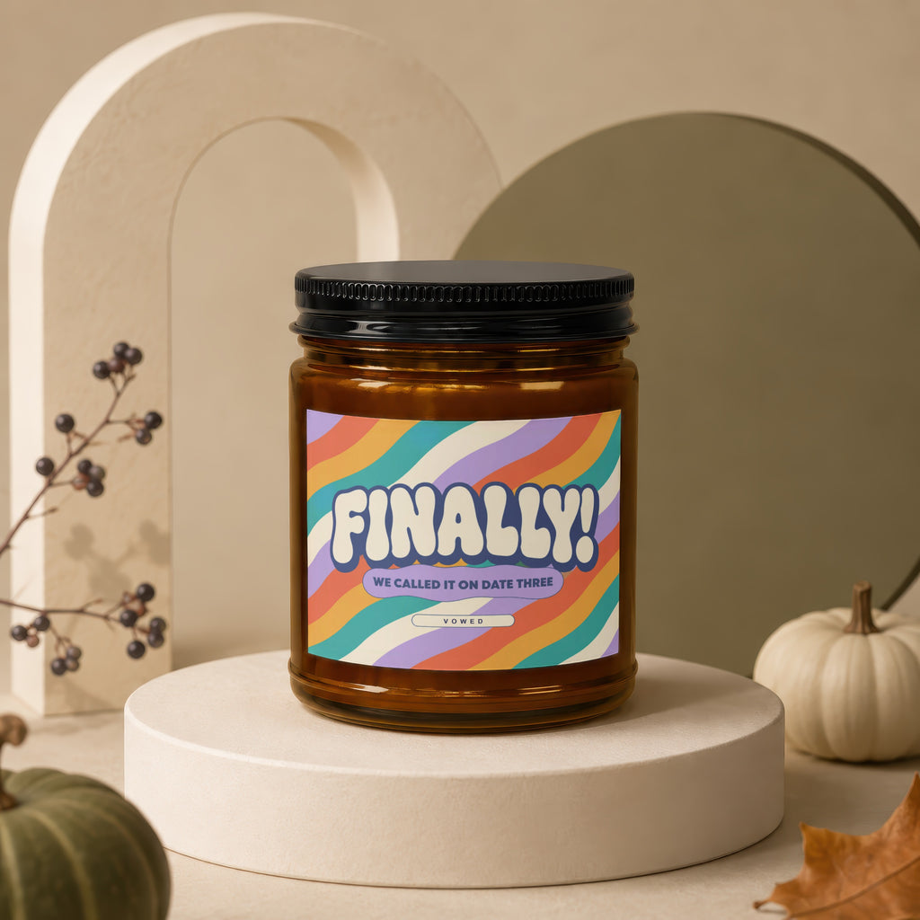 Glass candle with "FINALLY! WE CALLED IT ON DATE THREE VOWED" text on wavy background.