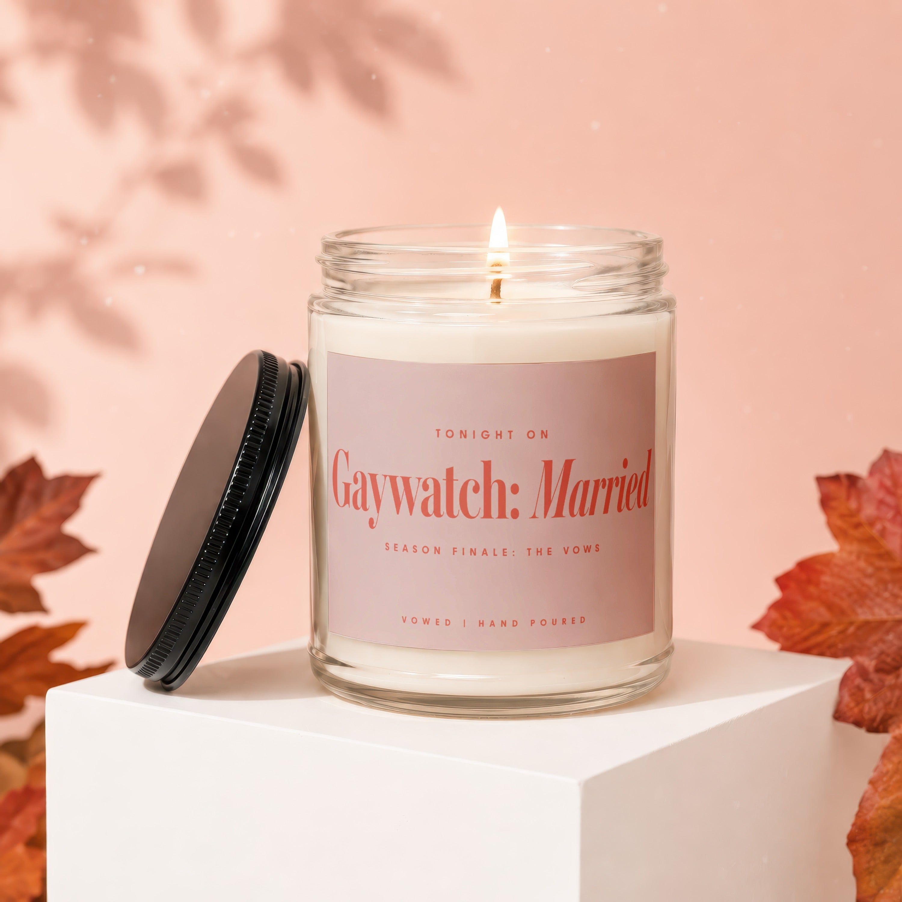 Lit candle with label "Gaywatch: Married Season Finale: The Vows" and lid.